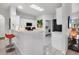 Well-lit kitchen with white cabinets, a breakfast bar, and modern appliances for a functional cooking space at 6929 Stetson Street Cir, Sarasota, FL 34243
