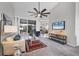 Bright living room featuring a sliding glass door, comfortable seating, and modern decor for relaxed living at 6929 Stetson Street Cir, Sarasota, FL 34243
