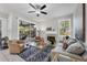 Bright living room features a fireplace, modern decor, and sliding glass doors to a patio at 6929 Stetson Street Cir, Sarasota, FL 34243