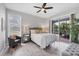 Main bedroom with plenty of light, neutral colors, and access to outdoor space at 6929 Stetson Street Cir, Sarasota, FL 34243