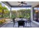 Covered and screened outdoor patio with a dining table and garden views at 6929 Stetson Street Cir, Sarasota, FL 34243