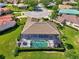 Aerial view of a home featuring screened-in pool, mature landscaping, and a well-manicured lawn at 7302 Dunes Ct, Bradenton, FL 34202