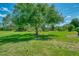 Large backyard with mature trees and green grass at 7302 Dunes Ct, Bradenton, FL 34202