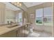 Well-lit bathroom with a vanity, sink, and a shower, with a modern vanity and natural light at 7302 Dunes Ct, Bradenton, FL 34202