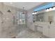 Elegant bathroom featuring dual sinks, a walk-in shower, and modern fixtures and finishes at 7302 Dunes Ct, Bradenton, FL 34202
