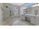 Elegant bathroom featuring dual sinks, a walk-in shower, and modern fixtures and finishes at 7302 Dunes Ct, Bradenton, FL 34202