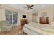 Spacious bedroom with wood floors, sliding glass doors to the lanai, and comfortable seating at 7302 Dunes Ct, Bradenton, FL 34202