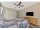 Bedroom with a comfortable bed, large closet, and wooden dresser, complete with ceiling fan and TV at 7302 Dunes Ct, Bradenton, FL 34202