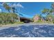 Clubhouse with a porte cochere for drop-off, and mature tropical landscaping at 7302 Dunes Ct, Bradenton, FL 34202