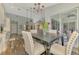 Charming dining area with elegant chandelier and view of the kitchen and outdoor space at 7302 Dunes Ct, Bradenton, FL 34202