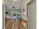 Bright foyer showcases hardwood floors, vaulted ceiling and living room with large windows at 7302 Dunes Ct, Bradenton, FL 34202