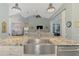 Open kitchen boasts stainless steel appliances, granite counters, and view into the living room at 7302 Dunes Ct, Bradenton, FL 34202