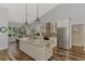 Spacious kitchen features granite island, stainless appliances, eat-in dining area and wooden floors at 7302 Dunes Ct, Bradenton, FL 34202