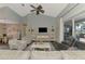 Bright living room with vaulted ceilings, modern furniture, and a view to the outdoor living area at 7302 Dunes Ct, Bradenton, FL 34202