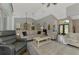 Spacious living room with vaulted ceiling and plenty of natural light is open to the kitchen at 7302 Dunes Ct, Bradenton, FL 34202