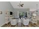 Well-lit living room with high ceilings and open floor plan design with an adjacent sunroom and kitchen at 7302 Dunes Ct, Bradenton, FL 34202