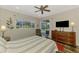 Serene main bedroom with a ceiling fan, backyard view, and sliding door access to the pool at 7302 Dunes Ct, Bradenton, FL 34202