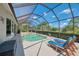 Backyard featuring a screened-in pool, outdoor lounge chairs, and a well-manicured lawn for serene outdoor living at 7302 Dunes Ct, Bradenton, FL 34202