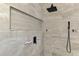 Modern walk-in shower featuring sleek tile work and a rainfall shower head at 7302 Dunes Ct, Bradenton, FL 34202