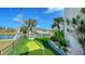 Backyard oasis with putting green, lush plants, artificial turf, and waterfront access at 795 Marbury Ln, Longboat Key, FL 34228