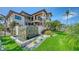 Beautiful backyard with verdant lawn, rock waterfall, and impeccable landscaping at 795 Marbury Ln, Longboat Key, FL 34228