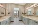 The bathroom features dual sinks, a spacious layout, and a balcony door, offering style and convenience at 795 Marbury Ln, Longboat Key, FL 34228