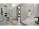 Modern bathroom featuring a glass shower, marble countertop sink, and elegant fixtures in a bright setting at 795 Marbury Ln, Longboat Key, FL 34228
