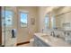 Bright bathroom featuring tiled shower, marble countertops, and a modern vanity at 795 Marbury Ln, Longboat Key, FL 34228