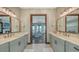 Elegant bathroom with double vanities, marble countertops, and view into the main bedroom at 795 Marbury Ln, Longboat Key, FL 34228