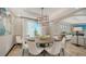 Beautiful dining area featuring a round table, stylish chairs, and a modern chandelier at 795 Marbury Ln, Longboat Key, FL 34228