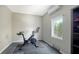 Well-lit exercise room featuring tile floors and a view of the outdoors at 795 Marbury Ln, Longboat Key, FL 34228