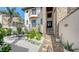 Exterior view showing stone accents, balconies, a landscaped yard with brick paver walkway leading to the front door at 795 Marbury Ln, Longboat Key, FL 34228