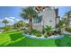 Exterior view of home featuring vibrant lawn, stone accenting, and meticulous landscaping at 795 Marbury Ln, Longboat Key, FL 34228