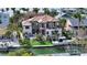 Luxury waterfront home with a boat lift, pool, and lush tropical landscaping at 795 Marbury Ln, Longboat Key, FL 34228