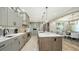 Open kitchen with large island, stainless steel appliances and an adjacent dining area at 795 Marbury Ln, Longboat Key, FL 34228