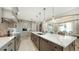 Bright kitchen with large island, pendant lighting, modern stainless steel appliances, and custom cabinetry at 795 Marbury Ln, Longboat Key, FL 34228