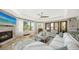 Bright living room with fireplace, comfortable seating, and scenic views from large windows at 795 Marbury Ln, Longboat Key, FL 34228
