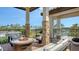 Outdoor lounge features comfortable seating around a fire pit, with views of the water and lush landscape at 795 Marbury Ln, Longboat Key, FL 34228