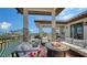 Comfortable outdoor seating surrounds a fire pit, perfect for relaxation and enjoying views of the canal at 795 Marbury Ln, Longboat Key, FL 34228