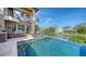 Outdoor pool area with an outdoor kitchen and canal views at 795 Marbury Ln, Longboat Key, FL 34228