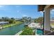 Stunning waterfront views from the balcony, overlooking the canal, pool, and docks at 795 Marbury Ln, Longboat Key, FL 34228