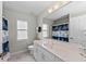 Bathroom with a large mirror, white cabinets, and nautical-themed shower curtain at 8106 Arlewood Cir, Port Charlotte, FL 33981