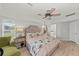 Bright bedroom with king bed, ceiling fan, and view of the lake at 8106 Arlewood Cir, Port Charlotte, FL 33981
