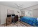 Bright bedroom with desk area, ceiling fan, and large window overlooking the outdoors at 8106 Arlewood Cir, Port Charlotte, FL 33981