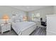 Well-lit bedroom with white furnishings, neutral colored walls and stylish floors at 8106 Arlewood Cir, Port Charlotte, FL 33981