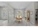 Formal dining room showcases marble floors, elegant chandelier, and large window with decorative shutters at 8106 Arlewood Cir, Port Charlotte, FL 33981