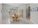 This light and airy dining room features marble floors, chandelier, and a large window with plantation shutters at 8106 Arlewood Cir, Port Charlotte, FL 33981