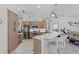 Bright kitchen with stainless appliances, island with marble countertop and pendant lighting at 8106 Arlewood Cir, Port Charlotte, FL 33981