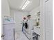 Laundry room featuring a washer, dryer, utility sink, and ample storage space at 8106 Arlewood Cir, Port Charlotte, FL 33981