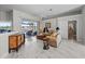 The sunny living area includes a view of the screened lanai, as well as stylish furnishings and marble floors at 8106 Arlewood Cir, Port Charlotte, FL 33981